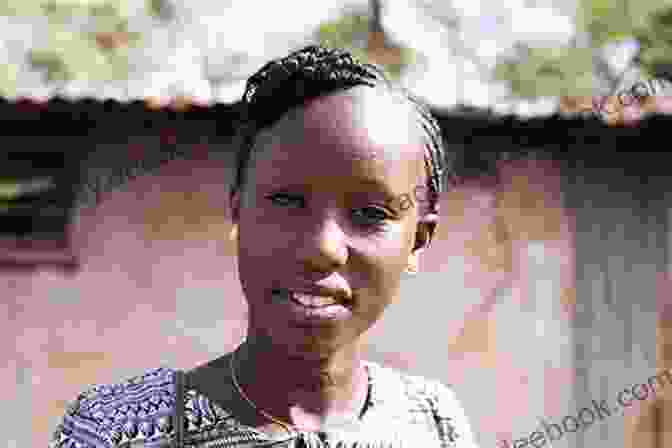 Nancy Nianci, A Young Woman From South Sudan, Stands Smiling In A Field. She Is Wearing A Traditional Dress And Has A Determined Expression On Her Face. Nancy Nianci: A Story Of Wars